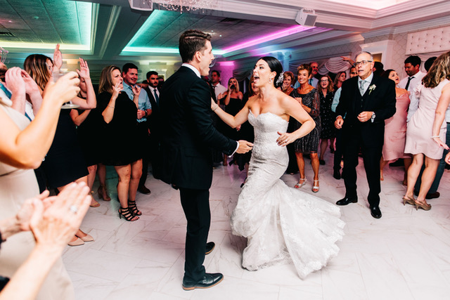 A newly married couple dances together at their wedding.